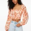 Dynamite Lisbet Long Sleeve Smocked Top In Orange Floral