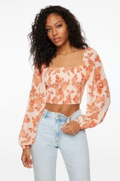 Dynamite Lisbet Long Sleeve Smocked Top In Orange Floral